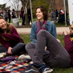 From left, Macomb senior, Marrissa Lesch, Grosse Ile senior, Rhys Scadden, and Leslie senior, Ty Bugbee lay in the lawn listening to Pinapple Psychology play during Central Michigan University's annual Maroonzie outside Wariner Hall, Friday, April 27, 2018.