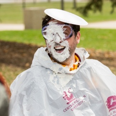 Student Activies and Involvement Assistant Director, Jordan Borchert, gets pied in the face during Central Michigan University's annual Maroonzie outside Wariner Hall, Friday, April 27, 2018.