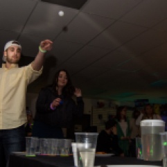 Central Michigan University sophomore Nick McClure and sophomore Lynnsey Polish play glow-in-the-dark water pong during an RPL 430 event Skate Back Bash at Northside Hansen Arena on Thursday, April 12, 2018.